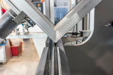 Operator bending metal sheet by sheet bending machine Stock Photos