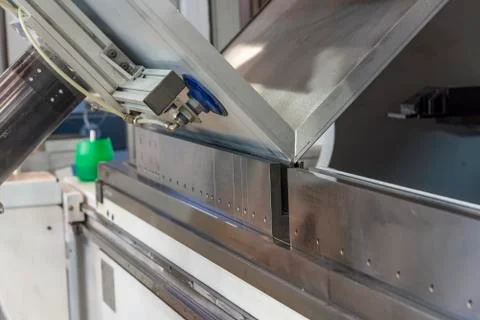 Operator bending metal sheet by sheet bending machine Stock Photos