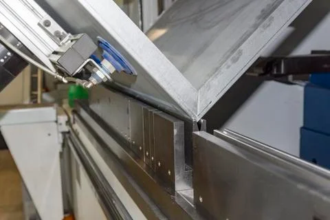Operator bending metal sheet by sheet bending machine Stock Photos