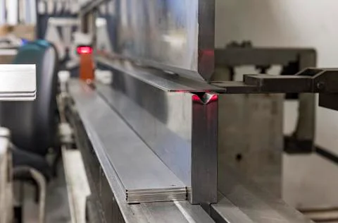 Operator bending metal sheet by sheet bending machine Stock Photos