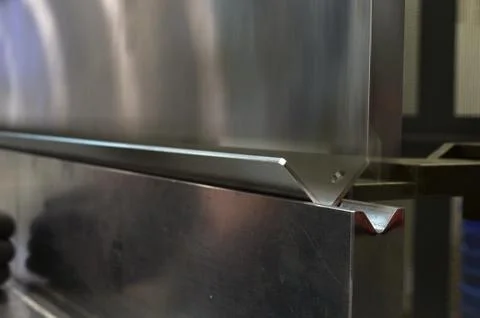Operator bending metal sheet by sheet bending machine Stock Photos