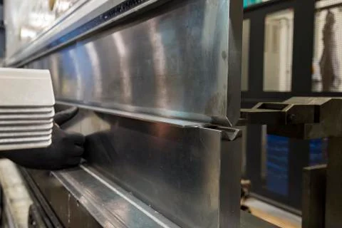 Operator bending metal sheet by sheet bending machine Stock Photos