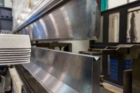 Operator bending metal sheet by sheet bending machine Stock Photos
