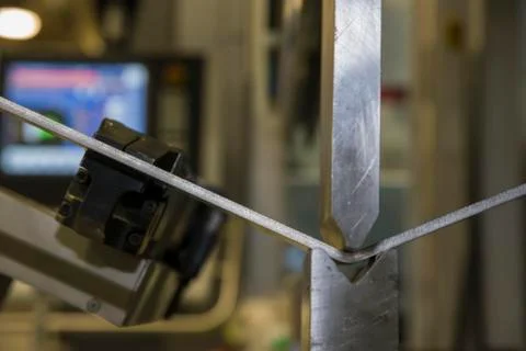 Operator bending metal sheet by sheet bending machine Stock Photos