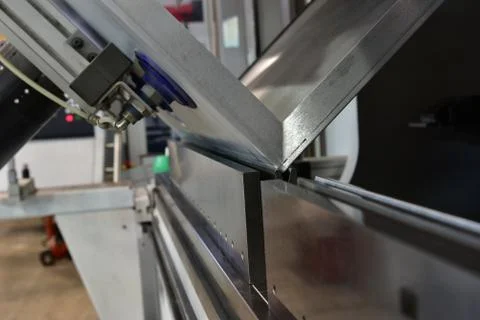 Operator bending metal sheet by sheet bending machine Stock Photos