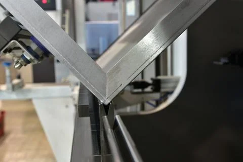 Operator bending metal sheet by sheet bending machine Stock Photos