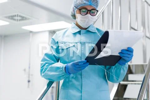 The operator checks the equipment for the production of sterile Stock Photos