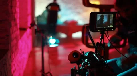 Operator cleans lens of professional videocamera Stock Footage 10681757