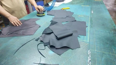 Operator cleans the marker pen ink on the surface leather. Stock Photos