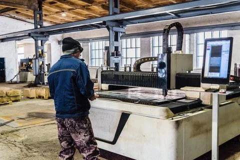 The operator of the CNC laser machine at work Stock Photos