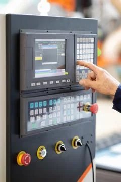 Operator of CNC machine working with control panel Stock Photos