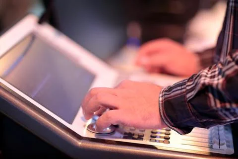 Operator at the compact lighting control console Stock Photos