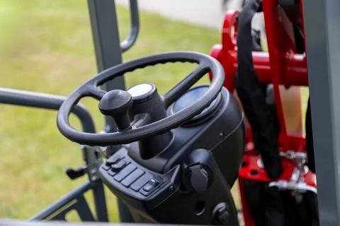 Operator control console with steering wheel and integrated controls Stock Photos