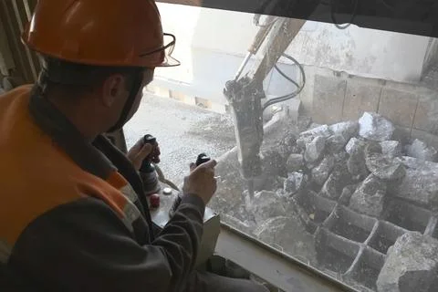 Operator at the control panel of hydraulic hammer Stock Photos