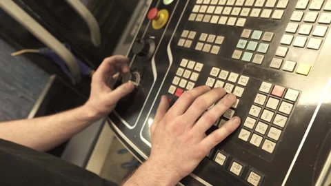 Operator Controlling CNC Machine via Control Panel Stock Footage 331371265