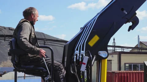 Operator controlling the industrial crane used for the transfer of the material Stock Footage 165680274