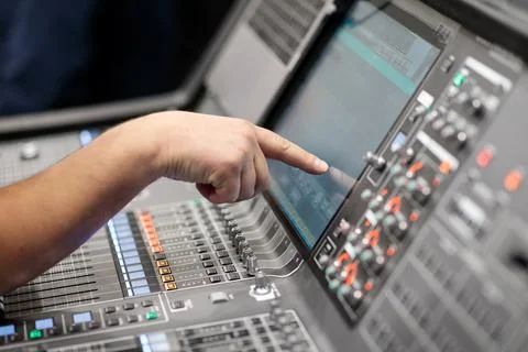 Operator controls digital audio mixing console Stock Photos