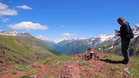Operator controls the drone. aerial shot in the mountains Stock Footage 79271261