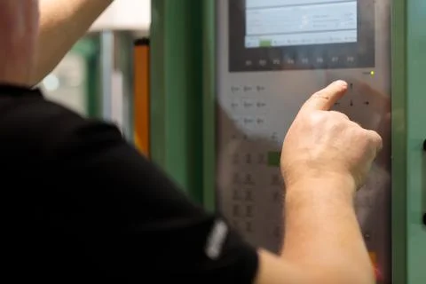 Operator controls machine with the control panel Stock Photos