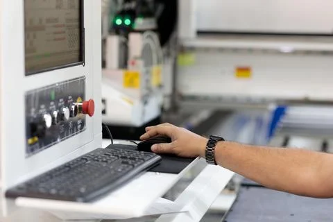 Operator controls a modern woodworking CNC machine Stock Photos
