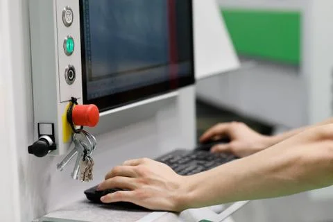 Operator controls operation of CAD CAM equipment Stock Photos