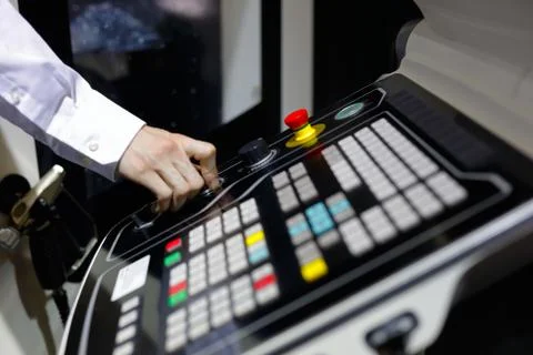 Operator controls the operation of the CNC machine Stock Photos