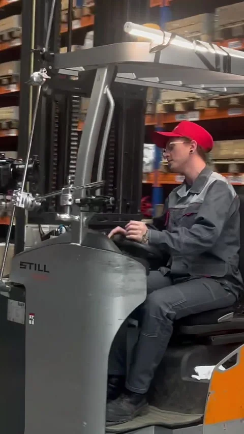 Operator drives forklift across spacious industrial hall Stock Footage 313866520