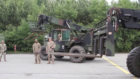 Operator driving military telescopic handler Stock Footage 90120734
