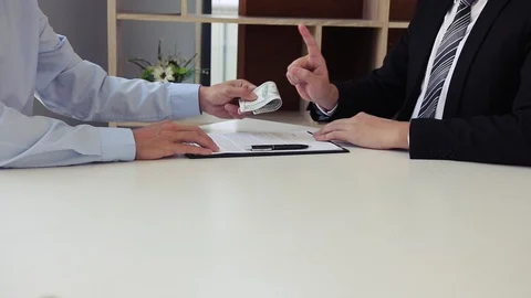 The operator employee submits documents and money to the manager while the ma 스톡 동영상 128295606