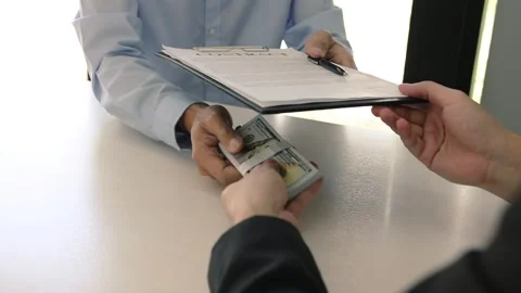 The operator employee submits documents contract and money to the manager whi 스톡 동영상 130305151