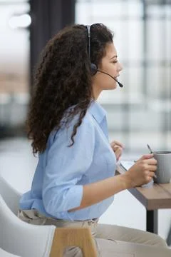 The operator enjoys fragrant coffee, taking a short break from work 스톡 사진