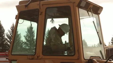 Operator exits backhoe Stock Footage 21563311
