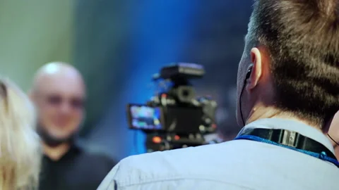 The operator is filming a man, defocused beyond recognition. Stock Footage 163376847