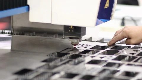 Operator fix steel sheet position by hand during laser cutting process Stock Footage 129994890