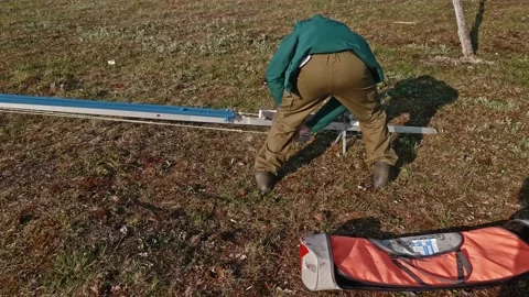 Operator fixes a rubber band on catapult to launch pilotless aircrafts Stock Footage 165896275
