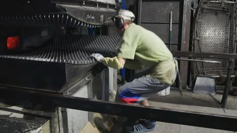 The operator of the furnace watching the process of bending glass. 스톡 동영상 122128377
