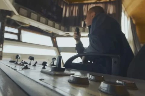 Operator of gold-mining walking multi-bucket excavator in the control cab. Stock Photos