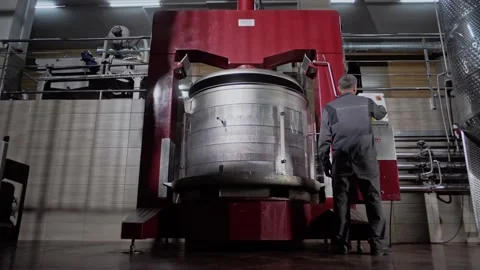 Operator of a grape press controls the operation of the machine at a winery. Stock Footage 270057913