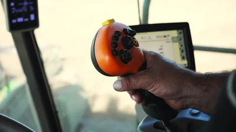 Operator Hand Controlling Joystick Inside Agricultural Machinery Cabin. Stock-Footage 346797346