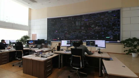 Operator with headset at table with computer in control room Stock Footage 156319843
