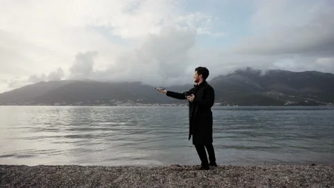 Operator holds control panel of the quadcopter against background of mountains Stock Footage 240054573