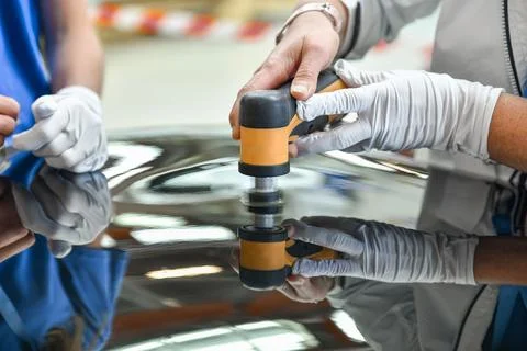 Operator holds a polisher in the hand for scratch Stock Photos