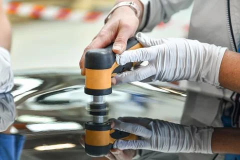 Operator holds a polisher in the hand for scratch Stock Photos