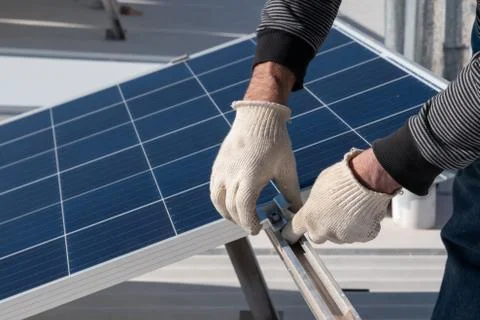 Operator installing solar equipment in residence Stock Photos