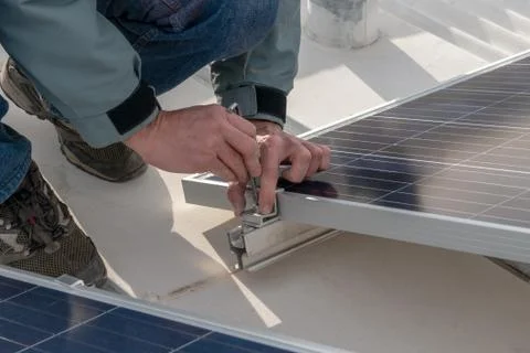 Operator installing solar equipment in residence Stock Photos