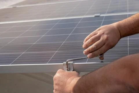 Operator installing solar equipment in residence Stock Photos