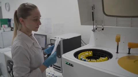 Operator lab assistant woman. Laboratory technician test blood in automatic Stock Footage 241028179