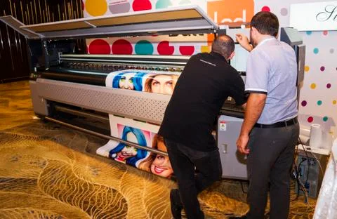 The operator on a large-format printer prints a photo Stock Photos