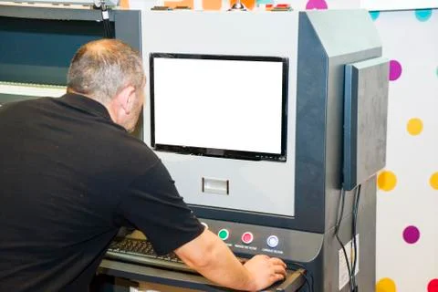The operator on a large-format printer prints a photo Stock Photos