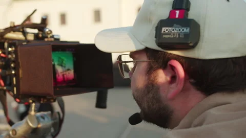 Operator leans toward screen reviewing detailed frames Видео 321944493